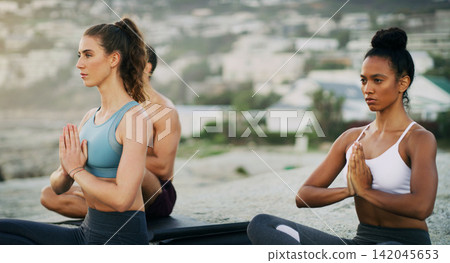 Women, hands and meditation on beach for calm with mindfulness balance, peaceful or spirituality. Female people, friends and ocean zen or holistic resort for environment retreat, healing or self care Women, hands and meditation on beach for calm with mindfulness balance, peaceful or spirituality. Female people, friends and ocean zen or holistic resort for environment retreat, healing or self care 142045653