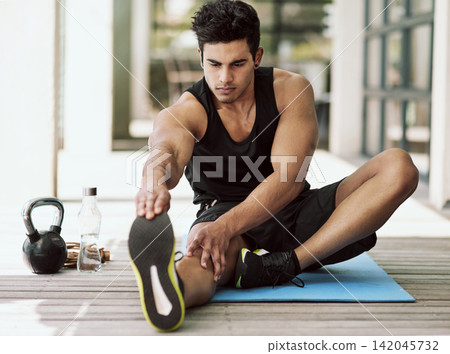 Man, stretching and exercise for legs in home and start with healthy preparation for workout. Training, flexibility and athlete warm up body with yoga for fitness, challenge and prevent sports injury 142045732