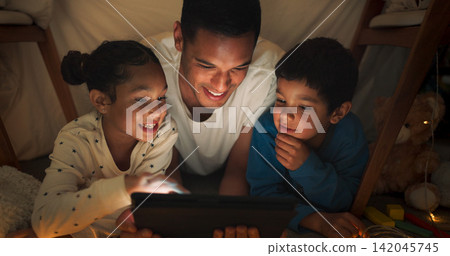 Night, father and kids with tablet for movie with streaming, blanket tent and sleepover with bonding, family and happy together. Evening, dad and children with technology, pajamas or fun with cartoon 142045745