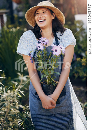 Gardening, woman and holding plant in outdoor for environment, sustainability or ecology. Nature, laughing and female person with apron for green nursery, agriculture or landscaping in backyard Gardening, woman and holding plant in outdoor for environment, sustainability or ecology. Nature, laughing and female person with apron for green nursery, agriculture or landscaping in backyard 142045787