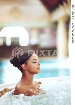 Woman, hot tub and relax calm at spa hotel for stress relief treatment or hydrotherapy, resort or hospitality. Female person, jacuzzi and lodge accommodation in Miami or hygiene, resting or travel Woman, hot tub and relax calm at spa hotel for stress relief treatment or hydrotherapy, resort or hospitality. Female person, jacuzzi and lodge accommodation in Miami or hygiene, resting or travel 142045803
