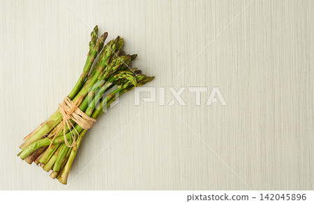 Asparagus, nutrition and vegan ingredients on table top for wellness, health and diet in studio. Vegetables, green and above isolated for eating, food and weight loss in house for prepare and cook. Asparagus, nutrition and vegan ingredients on table top for wellness, health and diet in studio. Vegetables, green and above isolated for eating, food and weight loss in house for prepare and cook. 142045896