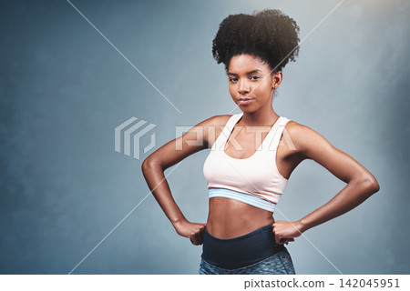 Studio, fitness and portrait of woman with confidence for exercise, workout and healthy body. Mockup, sports and face of athlete with pride for serious, training and wellness on blue background Studio, fitness and portrait of woman with confidence for exercise, workout and healthy body. Mockup, sports and face of athlete with pride for serious, training and wellness on blue background 142045951