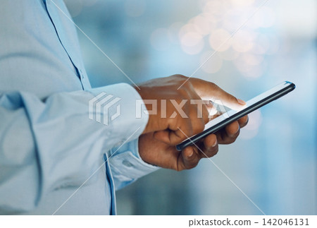 Black man, hands and browsing with phone for news, social media or online research at office. Closeup of African, male person or employee on mobile smartphone for chatting, texting or scrolling app Black man, hands and browsing with phone for news, social media or online research at office. Closeup of African, male person or employee on mobile smartphone for chatting, texting or scrolling app 142046131
