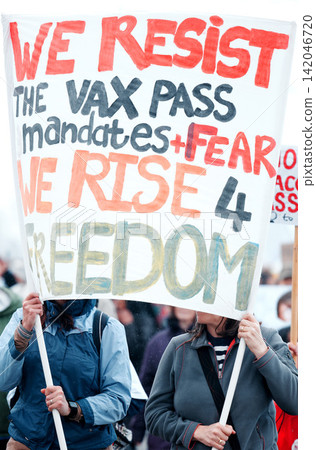Group, poster and protest in street for vaccine, covid and opinion with sign, medical and human rights. People, paper and crowd to stop pharma, choice and decision for health with freedom in city Group, poster and protest in street for vaccine, covid and opinion with sign, medical and human rights. People, paper and crowd to stop pharma, choice and decision for health with freedom in city 142046720
