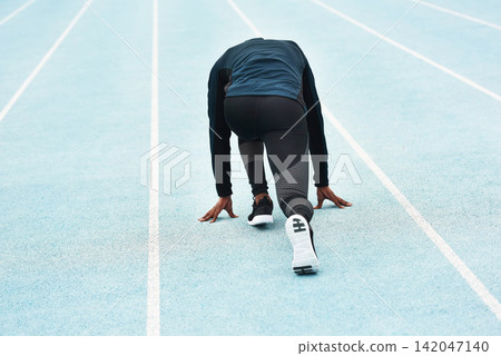 Running, fitness and person on track for race, challenge and competition for field event in stadium. Sports, health and back of runner at start for exercise, workout and sprint for marathon training Running, fitness and person on track for race, challenge and competition for field event in stadium. Sports, health and back of runner at start for exercise, workout and sprint for marathon training 142047140