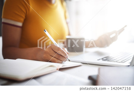 Book, writing and hands of person with laptop for working, network or research with technology in home. Student, studying or planning notes for online or exam, computer and connection for results Book, writing and hands of person with laptop for working, network or research with technology in home. Student, studying or planning notes for online or exam, computer and connection for results 142047158