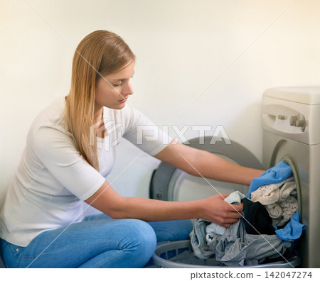 Woman, laundry and washing machine for cleaning in home, dirty clothes and routine housework. Female person, linen and fabric maintenance in apartment, sanitary and maid for hygiene housekeeping Woman, laundry and washing machine for cleaning in home, dirty clothes and routine housework. Female person, linen and fabric maintenance in apartment, sanitary and maid for hygiene housekeeping 142047274