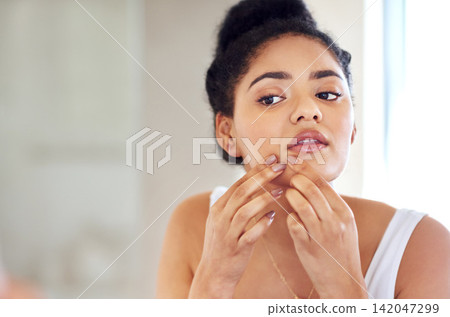 Skincare, face and woman popping pimple in mirror with mockup, dirt or scar on skin in home. Dermatology, facial wellness and girl in bathroom to squeeze acne, checking reflection or morning routine Skincare, face and woman popping pimple in mirror with mockup, dirt or scar on skin in home. Dermatology, facial wellness and girl in bathroom to squeeze acne, checking reflection or morning routine 142047299
