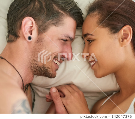 Couple, smile and lying in bed with love, happiness and care for morning conversation with partner. Happy, boyfriend and girlfriend connection with touch in home for communication or intimacy Couple, smile and lying in bed with love, happiness and care for morning conversation with partner. Happy, boyfriend and girlfriend connection with touch in home for communication or intimacy 142047376