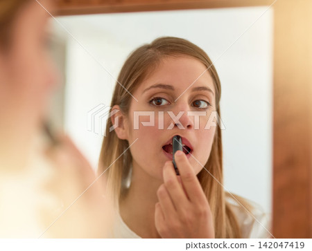 Woman, home and mirror with lipstick for beauty, reflection and confident with results. Female person, face and lips for appearance, aesthetics and cosmetics for transformation with self care Woman, home and mirror with lipstick for beauty, reflection and confident with results. Female person, face and lips for appearance, aesthetics and cosmetics for transformation with self care 142047419