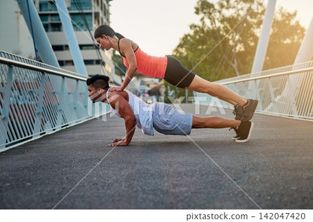 Couple, bridge and balance on back for fitness or daily exercise for training, pushup and workout partner for health. Man, girl and together outdoor for bonding for wellness or wellbeing and cardio. Couple, bridge and balance on back for fitness or daily exercise for training, pushup and workout partner for health. Man, girl and together outdoor for bonding for wellness or wellbeing and cardio. 142047420