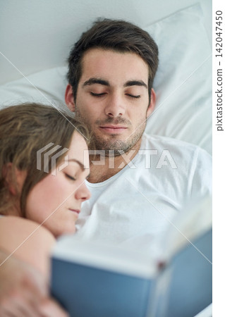 Love, relax and couple in bed with book, comfort and peace, care and bonding in their home from above. Calm, reading and male person with novel in bedroom with sleeping wife on weekend in a house Love, relax and couple in bed with book, comfort and peace, care and bonding in their home from above. Calm, reading and male person with novel in bedroom with sleeping wife on weekend in a house 142047450