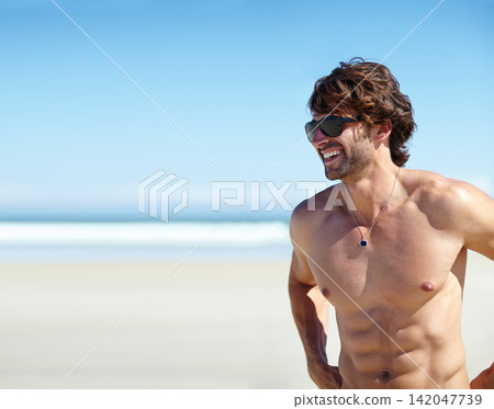 Man, shirtless and smile on beach for tan, outdoor recreation and vacation for summer trip and travel. Young person or male tourist and happy for bliss or enjoyment in sun for holiday break on mockup Man, shirtless and smile on beach for tan, outdoor recreation and vacation for summer trip and travel. Young person or male tourist and happy for bliss or enjoyment in sun for holiday break on mockup 142047739