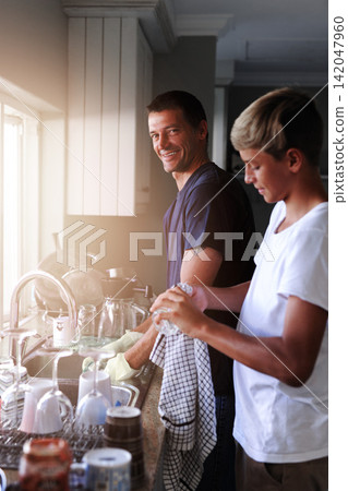 Father, boy and washing dishes to clean in kitchen, help and housework or teach hygiene in home. Daddy, son and teamwork and support with chore, care and protect from germs or bacteria for health Father, boy and washing dishes to clean in kitchen, help and housework or teach hygiene in home. Daddy, son and teamwork and support with chore, care and protect from germs or bacteria for health 142047960