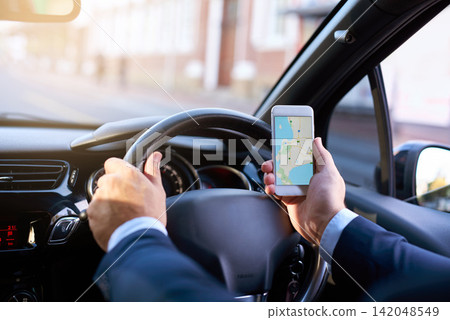 Driving, map and phone with business person in car to search for directions to location for commute. Hands, navigation and traffic with corporate employee in vehicle for travel to destination Driving, map and phone with business person in car to search for directions to location for commute. Hands, navigation and traffic with corporate employee in vehicle for travel to destination 142048549