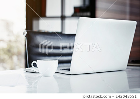 Empty office, desk and laptop or coffee for interior design, internet and minimal trend in workplace. Mug, tech and online for project or networking via email, planning and research on website Empty office, desk and laptop or coffee for interior design, internet and minimal trend in workplace. Mug, tech and online for project or networking via email, planning and research on website 142048551