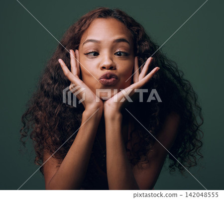 Woman, silly and face with goofy expression for funny joke, humor or comedy on a dark studio background. Young female person, brunette or quirky model with crazy pout, playful mind or fun attitude Woman, silly and face with goofy expression for funny joke, humor or comedy on a dark studio background. Young female person, brunette or quirky model with crazy pout, playful mind or fun attitude 142048555