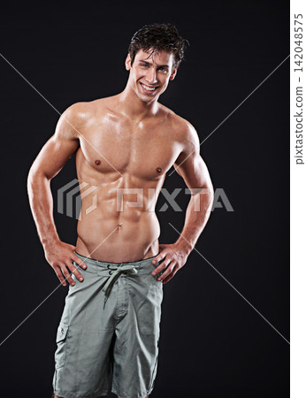Man, muscle and topless for fitness in portrait in studio for strength with training for wellness. Male person, workout and exercise on black background with flexing for confidence with happiness Man, muscle and topless for fitness in portrait in studio for strength with training for wellness. Male person, workout and exercise on black background with flexing for confidence with happiness 142048575