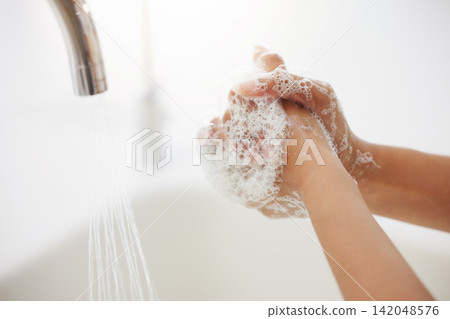 Woman, tap and washing hands with water or soap for hygiene, disinfection or bacteria and germ removal at home. Closeup of person by faucet, sink or basin with foam for cleanliness, health and safety Woman, tap and washing hands with water or soap for hygiene, disinfection or bacteria and germ removal at home. Closeup of person by faucet, sink or basin with foam for cleanliness, health and safety 142048576