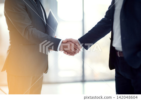 Handshake, business men and deal in an office with b2b and agreement from partnership. Corporate, collaboration and meeting with greeting and shaking hands from teamwork and welcome to company Handshake, business men and deal in an office with b2b and agreement from partnership. Corporate, collaboration and meeting with greeting and shaking hands from teamwork and welcome to company 142048604