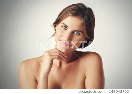 Smile, confidence and face of woman for skincare, beauty and dermatology with happiness isolated on gray background. Hand, skin and model natural with glow, wellness and soft on studio backdrop Smile, confidence and face of woman for skincare, beauty and dermatology with happiness isolated on gray background. Hand, skin and model natural with glow, wellness and soft on studio backdrop 142048703