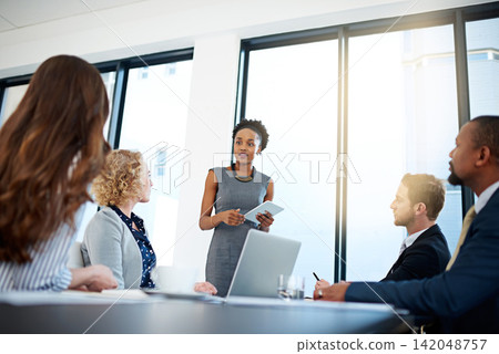 Business presentation, black woman or speaker on tablet for teaching, advice or skill development in meeting. Group, workshop or leader talking in pitch, training or coaching for learning opportunity Business presentation, black woman or speaker on tablet for teaching, advice or skill development in meeting. Group, workshop or leader talking in pitch, training or coaching for learning opportunity 142048757