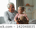 Grandfather and little baby girl grandchild playing colorful toys blocks. Caring granddad having fun with kids together at home. Old man, his granddaughter indoor. Seniors life. Happy Joy Family Video 142048835