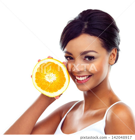 Portrait, smile and woman with orange, nutrition and sustainable eating to lose weight in studio. Fruit, face and girl with fresh food for detox diet, vitamin c and gut health on white background. Portrait, smile and woman with orange, nutrition and sustainable eating to lose weight in studio. Fruit, face and girl with fresh food for detox diet, vitamin c and gut health on white background. 142048917