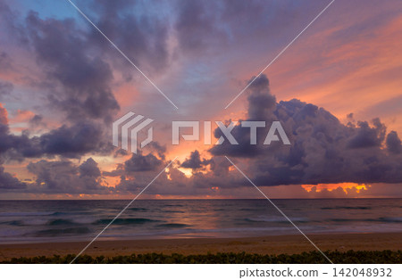 Aerial view of Vibrant Sunset Over Tranquil Beach Aerial view of Vibrant Sunset Over Tranquil Beach 142048932