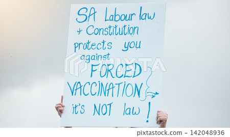 Hands, poster and protest for vaccine, covid and opinion with sign, medical and human rights in sky. Person, paper and board to stop pharma, choice and decision for health with freedom in street 142048936