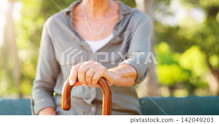 Elderly woman, park and hand with cane in nature for mobility support, balance and healthcare. Garden, sunshine and walking stick of person with a disability on bench for retirement, help and peace Elderly woman, park and hand with cane in nature for mobility support, balance and healthcare. Garden, sunshine and walking stick of person with a disability on bench for retirement, help and peace 142049203