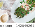 Fresh asparagus with sauce and bacon, on a white plate, sunlight, homemade, no people, 142049261