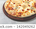 Freshly baked cheese pizza, white pizza, on a wooden plate, homemade, no people, 142049262