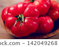 Pink tomatoes, in a rustic wooden bowl, close-up, no people, 142049268