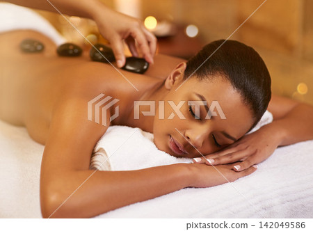 Spa, stone and woman with massage, wellness and relaxing with stress relief, skincare and vacation. Person, resort and girl with health, treatment and calm with zen therapy masseuse and body luxury Spa, stone and woman with massage, wellness and relaxing with stress relief, skincare and vacation. Person, resort and girl with health, treatment and calm with zen therapy masseuse and body luxury 142049586