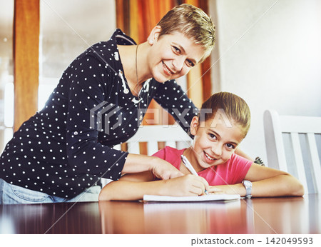 Mom, daughter and homework in portrait for learn with child development for education with writing, notebook and pen. Growth, study and homeschool at table with helping for assignment with paper Mom, daughter and homework in portrait for learn with child development for education with writing, notebook and pen. Growth, study and homeschool at table with helping for assignment with paper 142049593