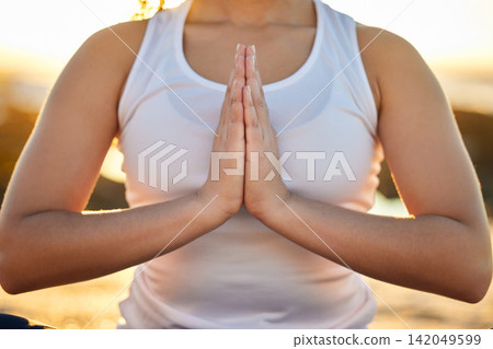 Hands, woman and sunset to meditate for peace or zen, calm and wellbeing or wellness and balance. Female person, outdoor and beach for mental health, mindset and relaxation for namaste with yoga Hands, woman and sunset to meditate for peace or zen, calm and wellbeing or wellness and balance. Female person, outdoor and beach for mental health, mindset and relaxation for namaste with yoga 142049599