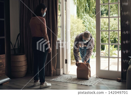 Woman, package and mask in house for health, courier service and customer care with safety. Delivery man, parcel and female person with face protection in home for ocd, bacteria and virus anxiety Woman, package and mask in house for health, courier service and customer care with safety. Delivery man, parcel and female person with face protection in home for ocd, bacteria and virus anxiety 142049701