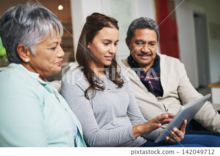 Senior parents, woman and tablet in living room for connection or bonding with technology. Family, home and mature people with young, female person and happy for togetherness on couch in community Senior parents, woman and tablet in living room for connection or bonding with technology. Family, home and mature people with young, female person and happy for togetherness on couch in community 142049712
