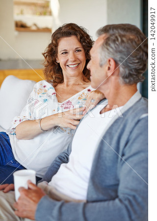 Smile, coffee or mature couple in home living room for conversation or communication in marriage. Happy, drinking tea or woman speaking to man in retirement, house or discussion to relax together Smile, coffee or mature couple in home living room for conversation or communication in marriage. Happy, drinking tea or woman speaking to man in retirement, house or discussion to relax together 142049917