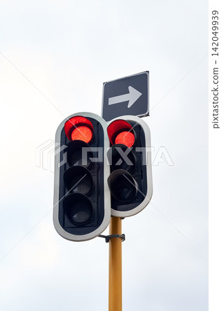 Traffic light, stop and street rules in city for transport direction or delay, commute or safety. Sign, red and arrow with warning for vehicle driving or urban travel with caution, downtown or road Traffic light, stop and street rules in city for transport direction or delay, commute or safety. Sign, red and arrow with warning for vehicle driving or urban travel with caution, downtown or road 142049939