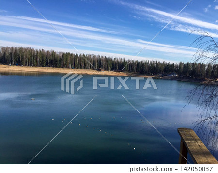 Calm Lake View Under Blue Sky Calm Lake View Under Blue Sky 142050037