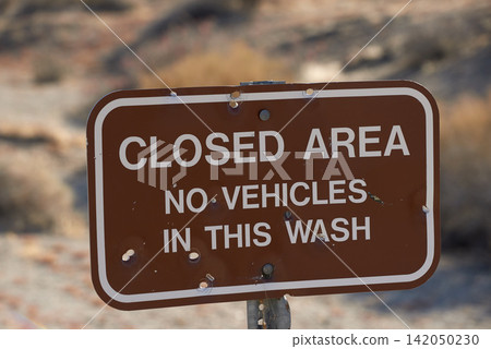 Desert, closed or sign outdoor in nature, landscape or background in Anza Borrego state park wash in California. Travel, land or restricted environment in summer on dead end, caution or notice in USA Desert, closed or sign outdoor in nature, landscape or background in Anza Borrego state park wash in California. Travel, land or restricted environment in summer on dead end, caution or notice in USA 142050230