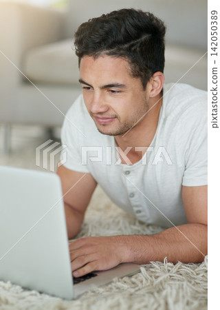 Man, laptop and student for education in home, floor and browse for research on college project. Male person, lounge and university website for course, assignment and app for study or online class Man, laptop and student for education in home, floor and browse for research on college project. Male person, lounge and university website for course, assignment and app for study or online class 142050389
