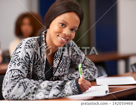 University, exam and portrait of black girl in classroom for education, development or scholarship. Campus, paper and face of student with test at academy for future, learning and knowledge in school University, exam and portrait of black girl in classroom for education, development or scholarship. Campus, paper and face of student with test at academy for future, learning and knowledge in school 142050469