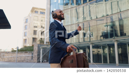 Business man, dancing and headphones in city with smile, steps and spin with bag for commute by office buildings. Person, employee or excited dancer with music, briefcase or outdoor on metro sidewalk Business man, dancing and headphones in city with smile, steps and spin with bag for commute by office buildings. Person, employee or excited dancer with music, briefcase or outdoor on metro sidewalk 142050538