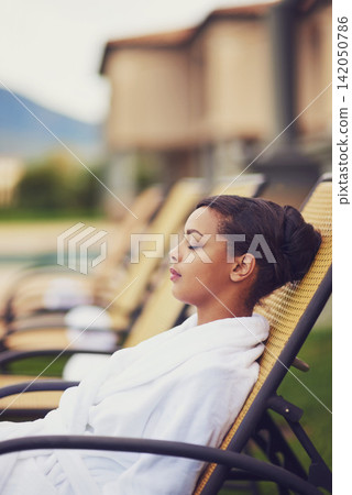 Spa, woman and peace for health, wellness and lounge in zen, beauty and healing on holiday. Female person, outdoor in detox for body care with eyes closed, calm and relaxed on vacation in Italy Spa, woman and peace for health, wellness and lounge in zen, beauty and healing on holiday. Female person, outdoor in detox for body care with eyes closed, calm and relaxed on vacation in Italy 142050786