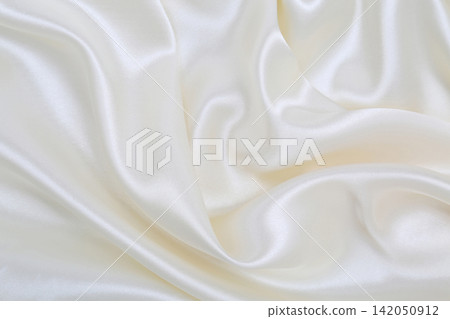 Smooth elegant white silk or satin luxury cloth texture as wedding background. Luxurious background design Smooth elegant white silk or satin luxury cloth texture as wedding background. Luxurious background design 142050912