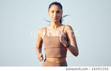 Portrait, fitness and woman running outdoor for body health, wellness or exercise on sky background mockup space. Face, cardio and person training for sport, marathon race or summer workout in Dubai Portrait, fitness and woman running outdoor for body health, wellness or exercise on sky background mockup space. Face, cardio and person training for sport, marathon race or summer workout in Dubai 142051334